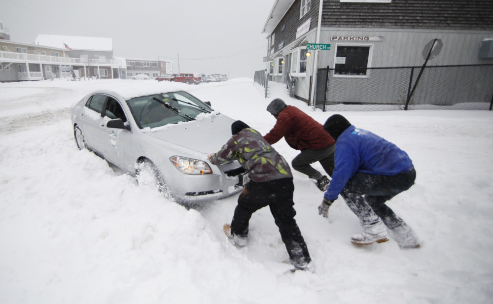 Nick Buonanno, Braden Haskell and Kurt Wenzel help a motorist whose car became stuck in a snowbank at Mile Road and Church Street in Wells during the season’s first snow. The Dec. 29 storm is the second-latest snowfall in Portland’s history; the record is Jan. 16, 2000.