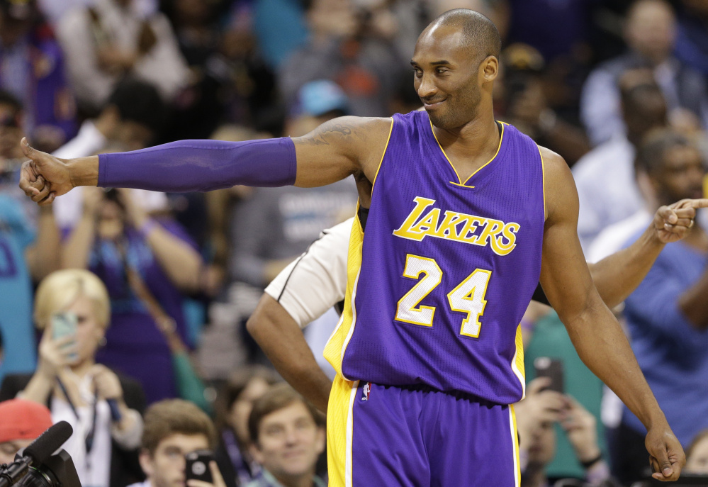 Kobe Bryant of the Los Angeles Lakers gives a thumbs-up before Monday’s game against the Hornets in Charlotte, N.C. – one more stop on a farewell tour for the retiring superstar who comes to Boston on Wednesday.