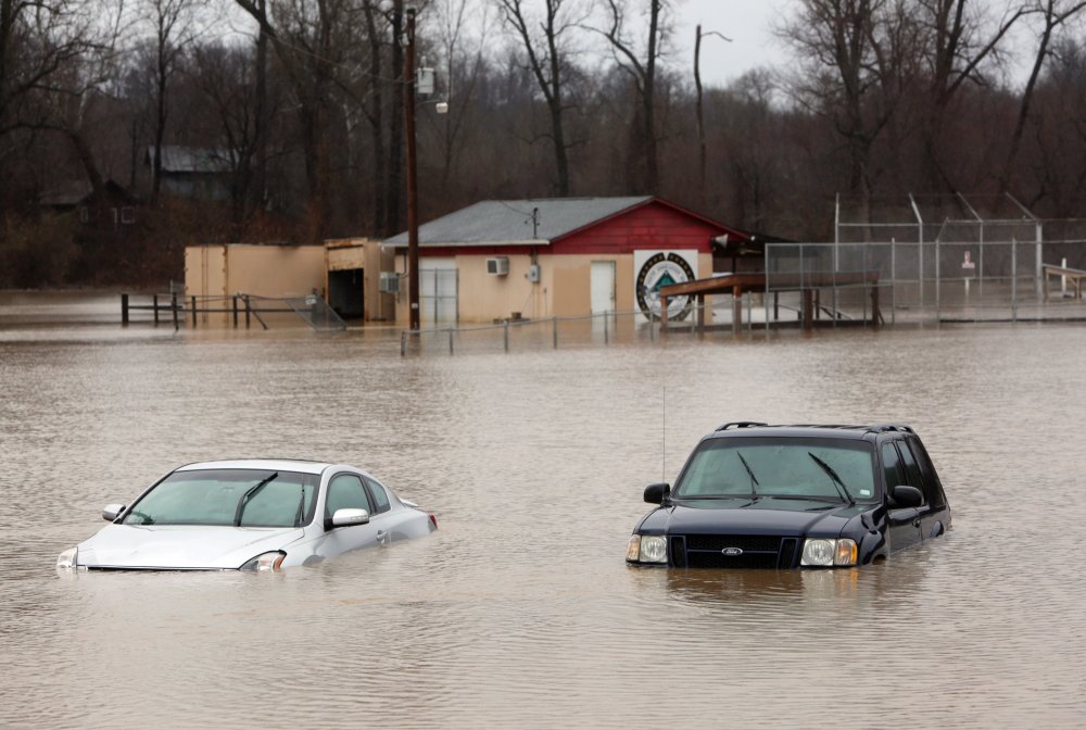 Abandoned cars sit on the flooded parking lot of the Imperial Youth Association Ball Fields in Kimmswick, Mo.