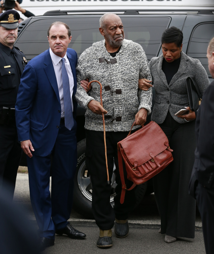 Bill Cosby is helped as he arrives for his court appearance Wednesday in Elkins Park, Pa.