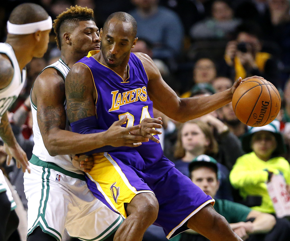 Los Angeles Lakers' Kobe Bryant moves on Boston Celtics' Marcus Smart during the second quarter of an NBA basketball game in Boston on Wednesday, Dec. 30, 2015. (AP Photo/Winslow Townson)