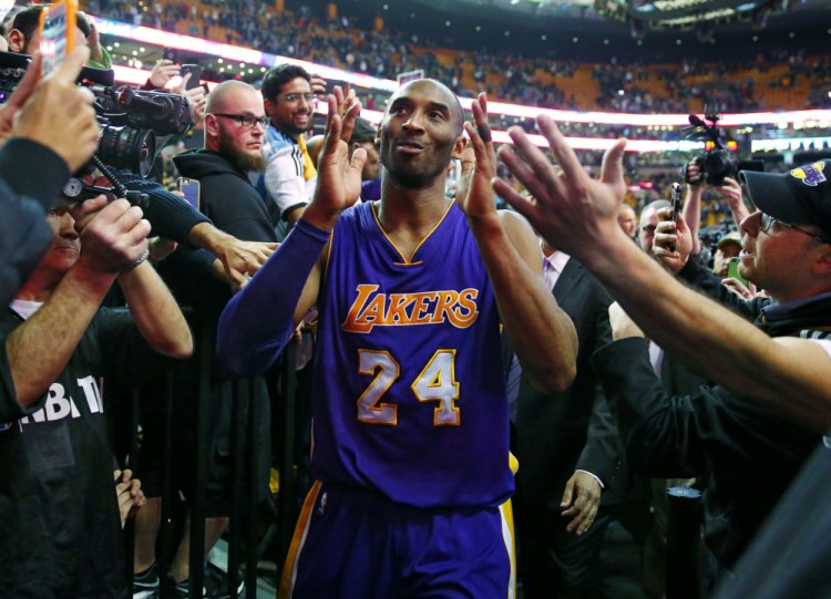 Kobe Bryant acknowledges the fans as he walks off the TD Garden court after the Lakers’ 112-104 win over the Celtics in his last game in Boston.