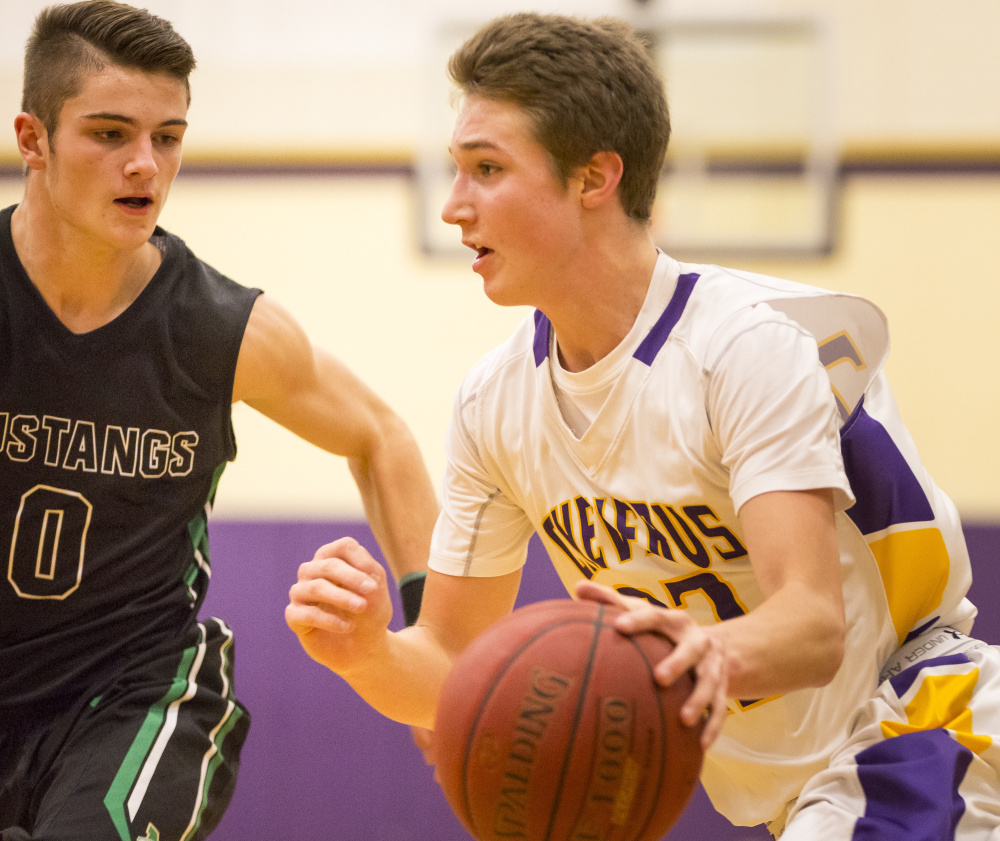 Jack Casale, who scored a game-high 25 points for Cheverus, heads to the basket while defended by Dawson Renaud of undefeated Massabesic.