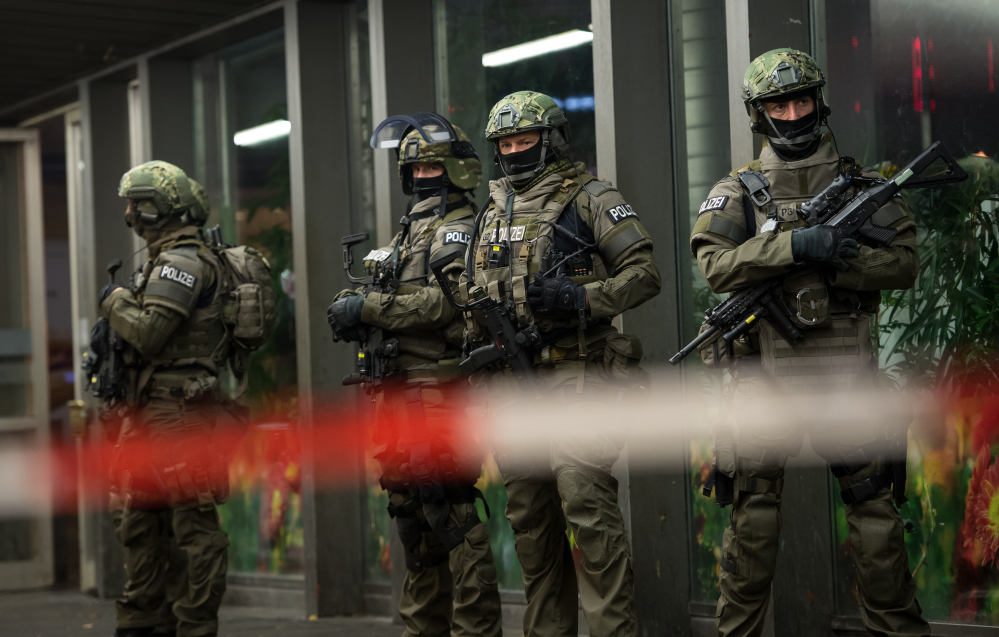 German special police stand in front of Munich’s main train station Thursday evening after police warned of an “imminent threat” of a terror attack and ordered two train stations cleared.