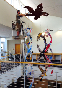 Neil Bruns installs "All Life Interrelated," a sculpture by Kate Cheney Chappell, at Kingswood Oxford School in West Hartford, Conn. (Photo courtesy of Kate Cheney Chappell)