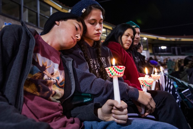 The McIntyre family from Redlands, Calif., hold candles at a vigil Thursday, in remembrance of the 14 people killed Wednesday in the San Bernardino mass shooting. The parents are middle school teachers.
Tom Tingle/The Arizona Republic via AP