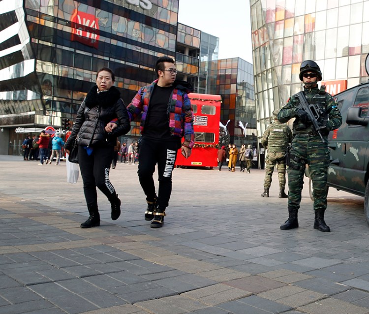 Heavily armed Chinese paramilitary police guard a popular mall in the Sanlitun district of Beijing, China. Increased security could be seen in the area as the U.S. and British embassies in the Chinese capital issued travel alerts regarding the possible threats against westerners.