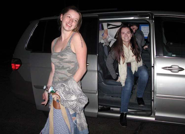 Kat Dolan, left, Mary Roche and Sarah Ferrigno, all freshmen at the University of Connecticut, exit a Sober XPress van at an apartment complex in Storrs, Conn. The students are regular customers of the ride-booking business which caters to college students needing a designated driver to and from parties and bars. The Associated Press