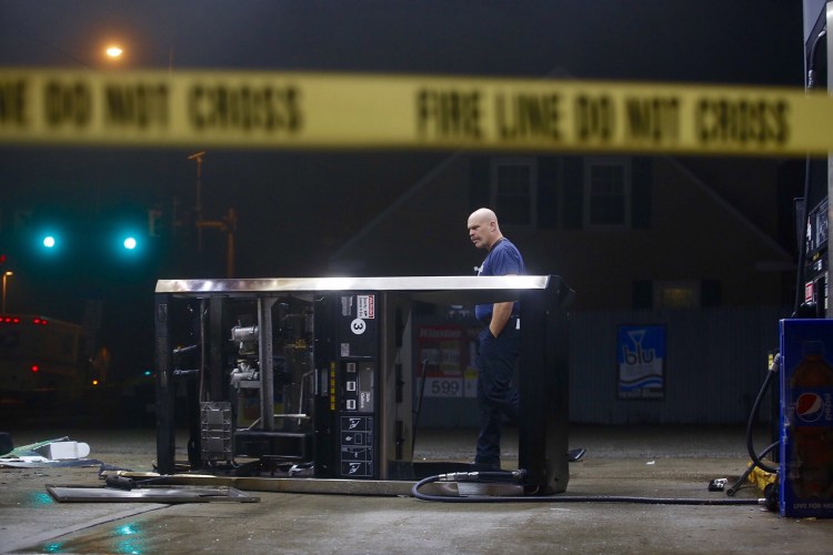 Portland Deputy Fire Chief Shawn Neat surveys the scene of an accident at a gas station on Forest Avenue on Wednesday.
Derek Davis/ Staff Photographer