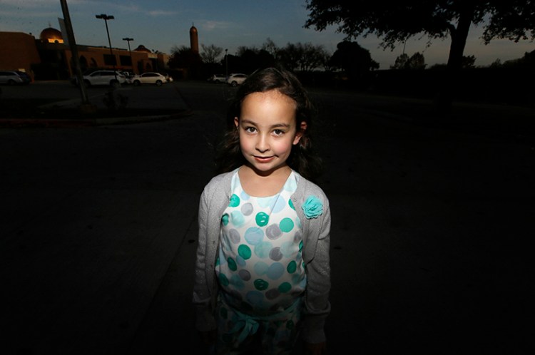 Sofia Yassini, 8, poses outside a mosque in Richardson, Texas. After seeing presidential candidate Donald Trump call on television for barring Muslims from entering the country, the 8-year-old started packing her favorite things and checking the locks on the doors because, in her mind, Donald Trump’s push to ban Muslims entering the country meant the Army would come and rip her family from their home. 