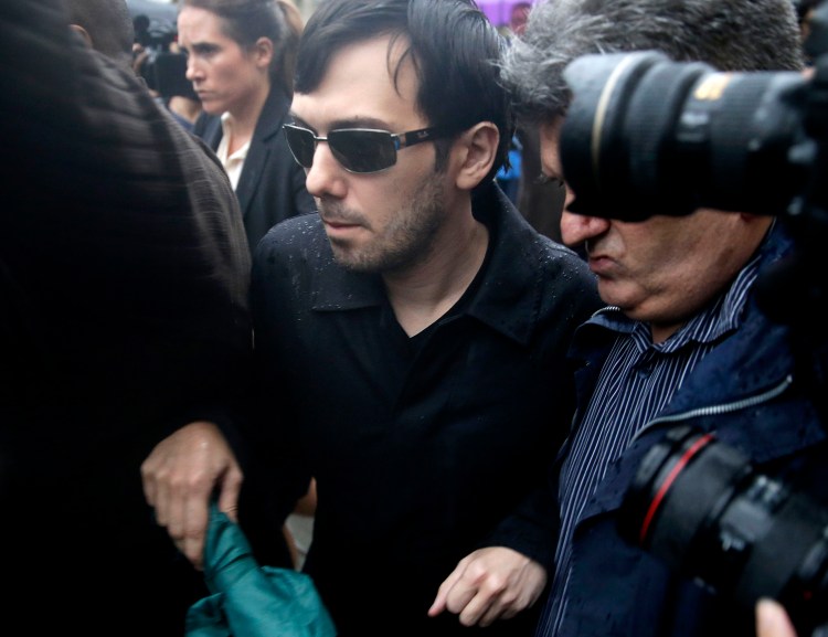 Martin Shkreli leaves the courthouse after his arraignment in New York, Thursday, Dec. 17, 2015. Shkreli, the former hedge fund manager vilified in nearly every corner of America for buying a pharmaceutical company and jacking up the price of a life-saving drug more than fiftyfold, was arrested Thursday on securities fraud charges unrelated to the furor. (AP Photo/Seth Wenig)