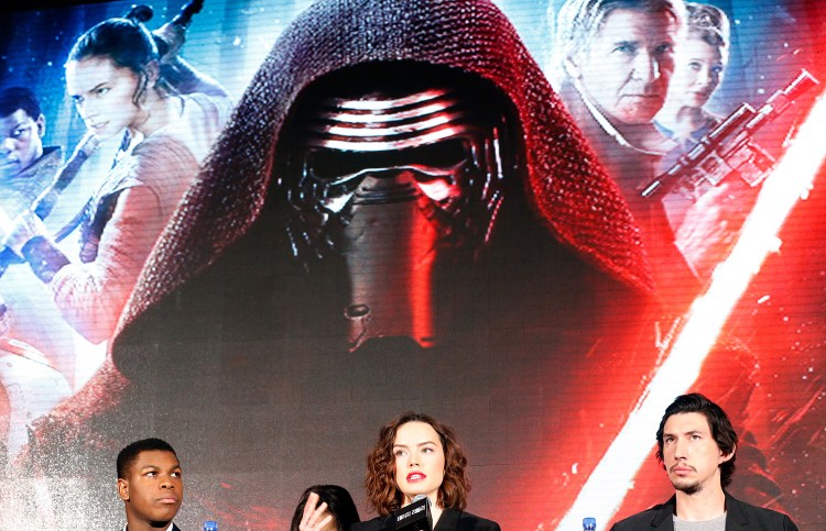 British actress Daisy Ridley, center, answers a reporter's question as British actor John Boyega, left, and U.S. actor Adam Driver listen during a press conference in Seoul, South Korea.