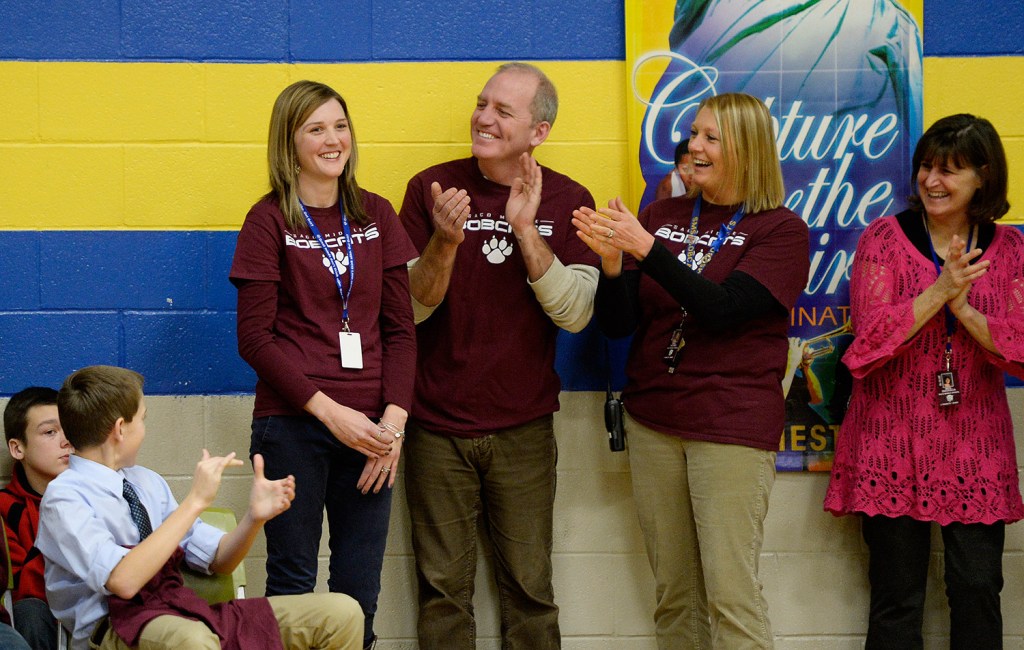 Saco Middle School eighth-grade science teacher Michaela Lamarre, left, is cheered by faculty, staff and students after it was announced that she will receive a Milken Educator Award and $25,000 on Thursday. L to R, are Lamarre, Ron Letourneau, Joan Holmes and Sandy DaGraca.