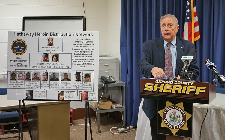 Maine Department of Public Safety Commissioner John Morris speaks at a news conference announcing the "largest drug investigation in Oxford County history." Next to him is a poster charting those who have been arrested.
