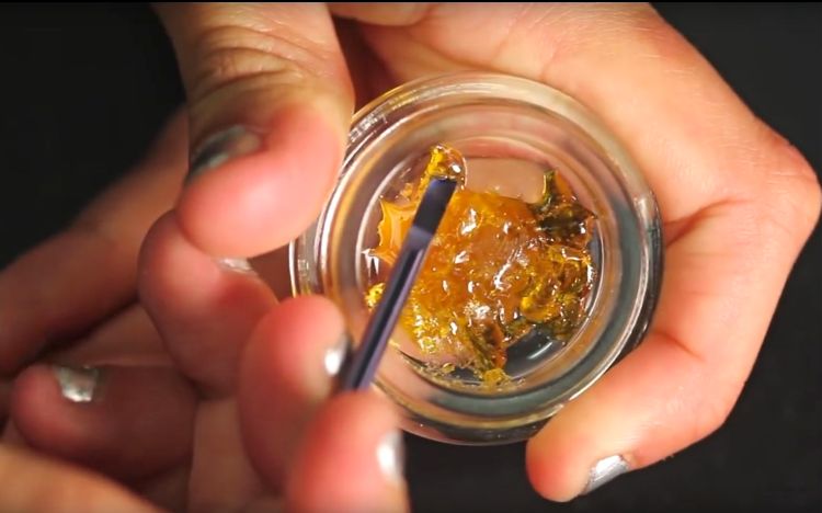 Shatter as it looks before it is formed into thin, translucent layers for sale. Users typically heat and inhale it through a vaporizer rather than smoke it. Image from HighTimes YouTube video