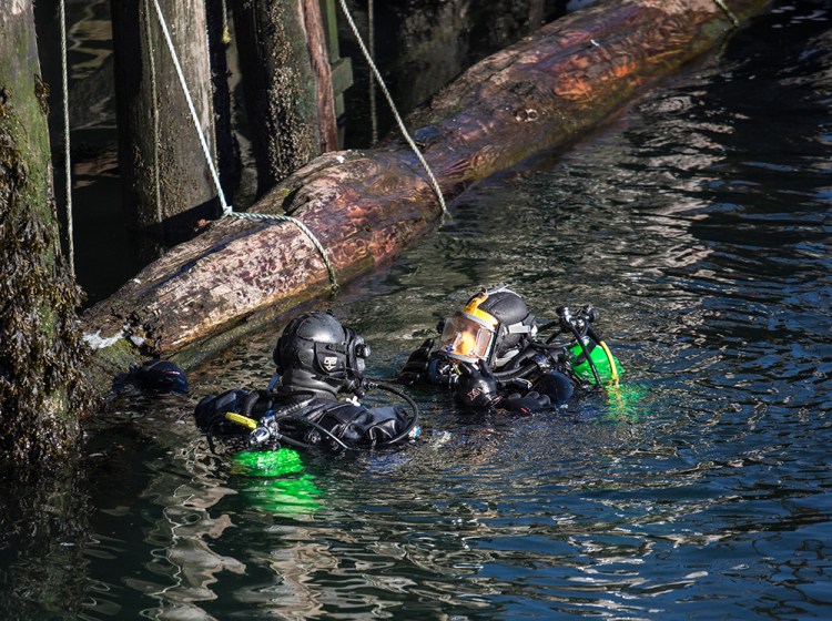 Divers from the Portland and South Portland police departments continue their search for missing person James Dyer near Union Wharf in Portland on Tuesday. Whitney Hayward/Staff Photographer