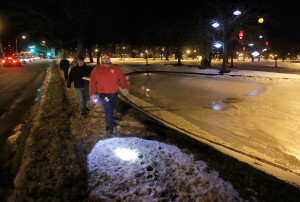 PORTLAND, MAINE - JANUARY 27, 2016: Mike Guthrie, front, and Norman Maze lead a group along the pond in Deering Oaks Park along looking for homeless people during the annual point-in-time homeless count on Wednesday, January 27, 2016. Guthrie works for the City of Portland as a navigator for the Home to Stay program and Maze is the housing director for Shalom House. (Photo by Gregory Rec/Staff Photographer)