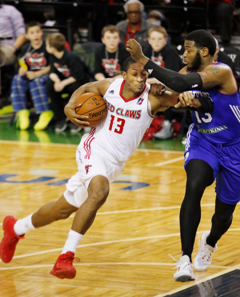 Maine’s Malcolm Miller, left, drives for the basket while being guarded by Delaware’s David Laury III during the Red Claws’ 118-112 loss Sunday at the Portland Expo which snapped a five-game winning streak. Joel Page/Staff Photographer