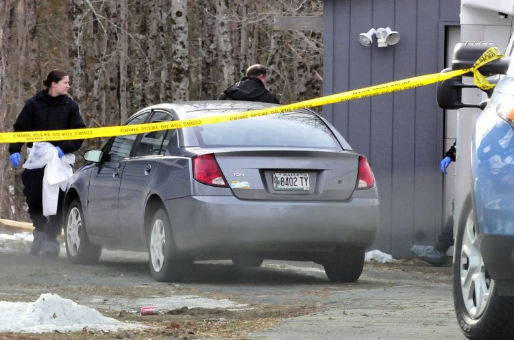 State police investigators search one of two vehicles and enter the garage at 457 Norridgewiock Road in Fairfield on Tuesday.
David Leaming/Morning Sentinel