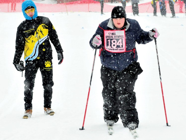 Caitlin Killarney of Families Matter Inc. in Waterville competes in the 2014 Special Olympics Maine Winter Games at Sugarloaf. At left, Colby Watts of Maranacook High School cheers her on.
Kennebec Journal file photo