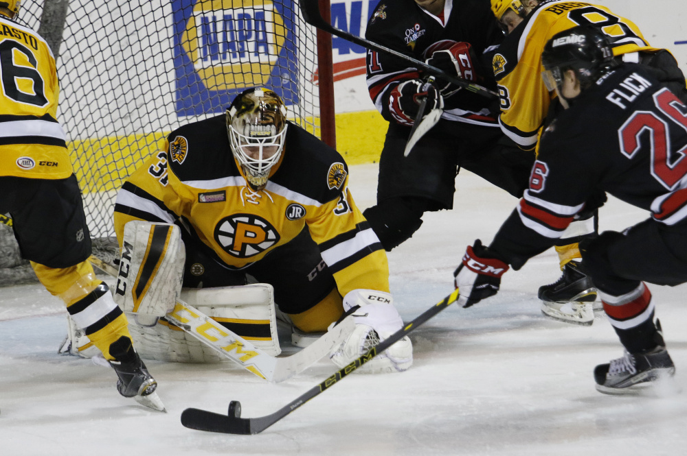 Rob Flick of the Portland Pirates prepares to put the puck past goalie Zane McIntyre of the Providence Bruins during the third period of  the Pirates’ 4-3 victory Thursday – the second game of the Red Claws-Pirates doubleheader in Portland. Both teams also will be home Saturday.