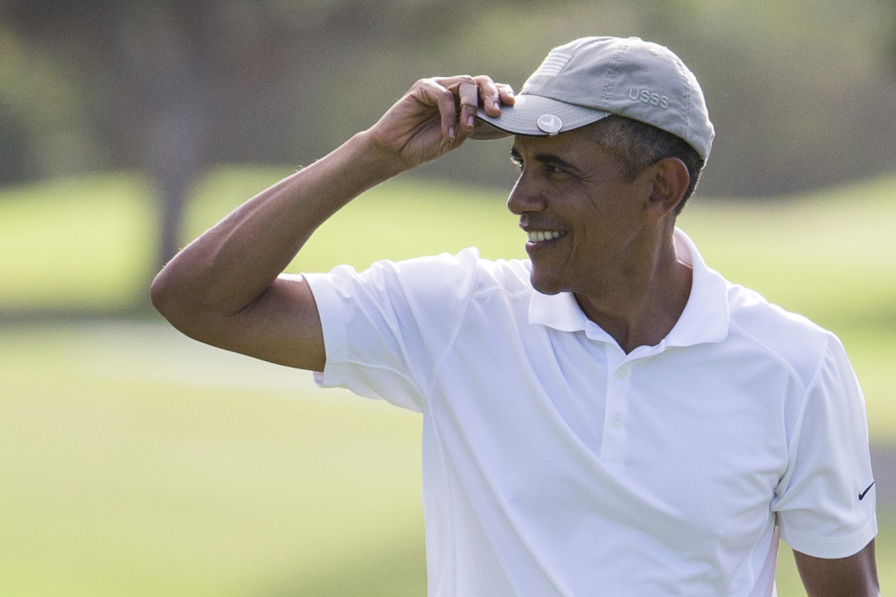 President Barack Obama tips his hat to the crowd after finishing a round of golf at Mid-Pacific Country Club during his family vacation on Monday in Kailua, Hawaii.