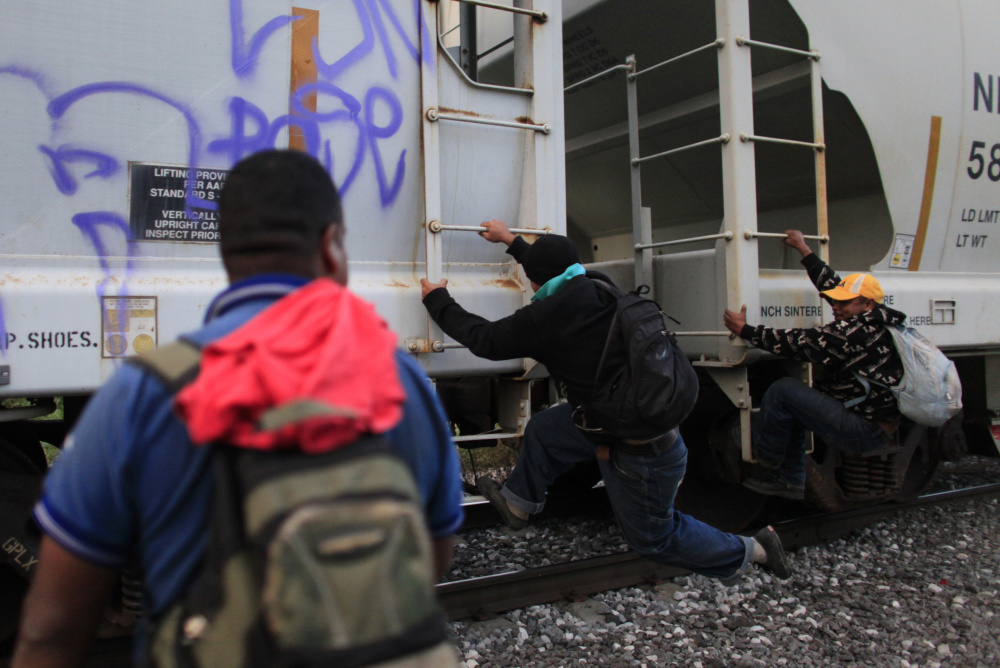 Honduran immigrants climb aboard a freight train heading toward the U.S. border in Orizaba, Mexico. Only those who meet the legal criteria should be granted asylum in the U.S. – having fled urban violence in Central America should not be enough to gain entry.