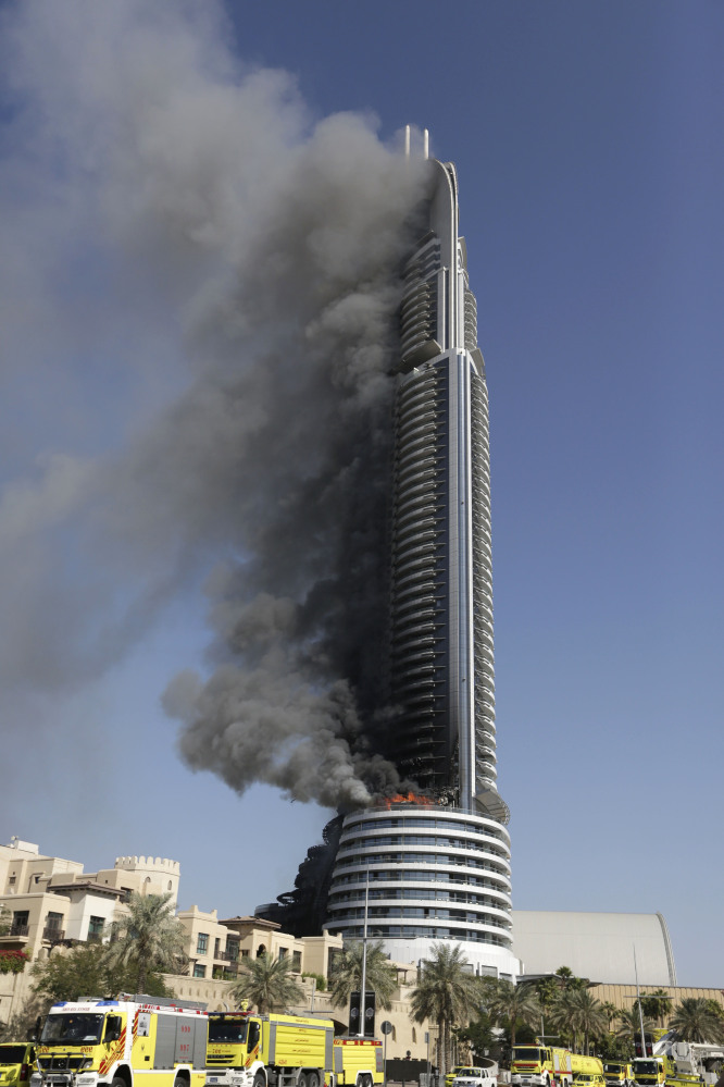 Smoke pours from a 63-floor skyscraper in Dubai, United Arab Emirates, on Friday. The blaze began Thursday night before Dubai’s annual New Year’s Eve fireworks show near the Burj Khalifa, the world’s tallest building. which sits nearby.