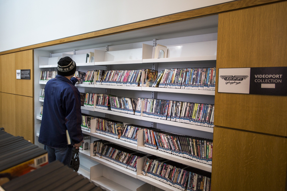 Cory Legassie of Portland looks at DVDs donated to the Portland Public Library by Videoport, the Old Port video store that went out of business in August after 28 years. “I miss Videoport, so it’s good to seem them back in some form or another,” he said.