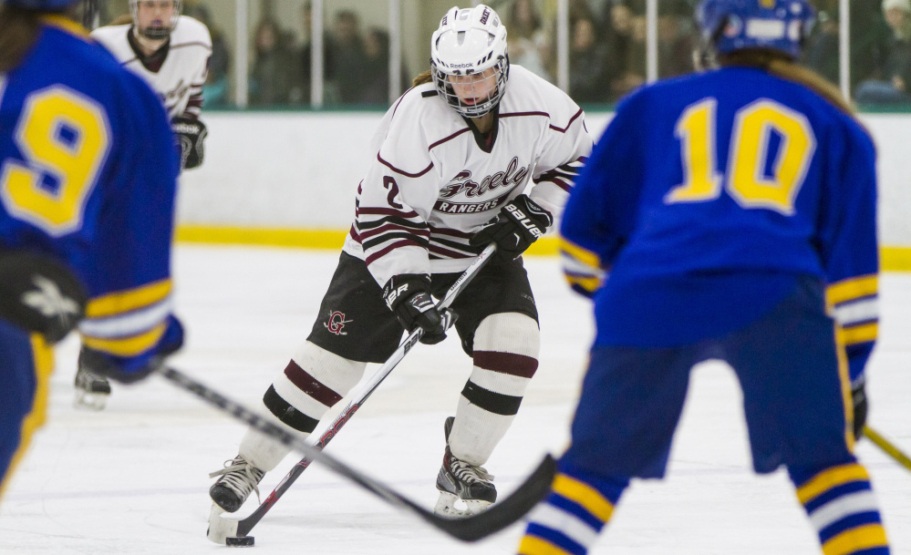 Greely senior Maura Verrill keeps the puck in the offensive zone Friday against Falmouth. Ben McCanna/Staff Photographer