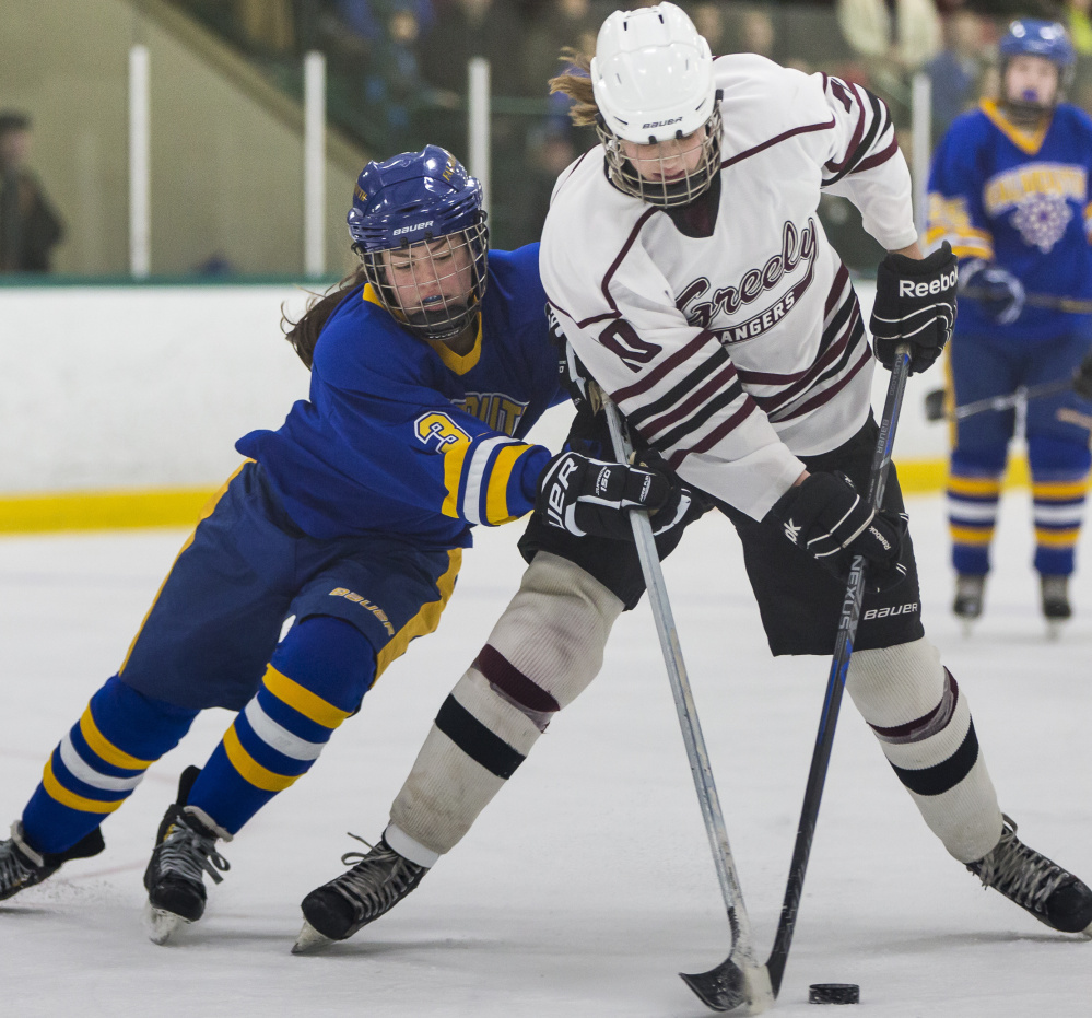 Falmouth’s Kayla Sarazin, left, attempts to take the puck away from Greely’s Courtney Sullivan during their game Friday at Family Ice Center. Greely won, 3-0.