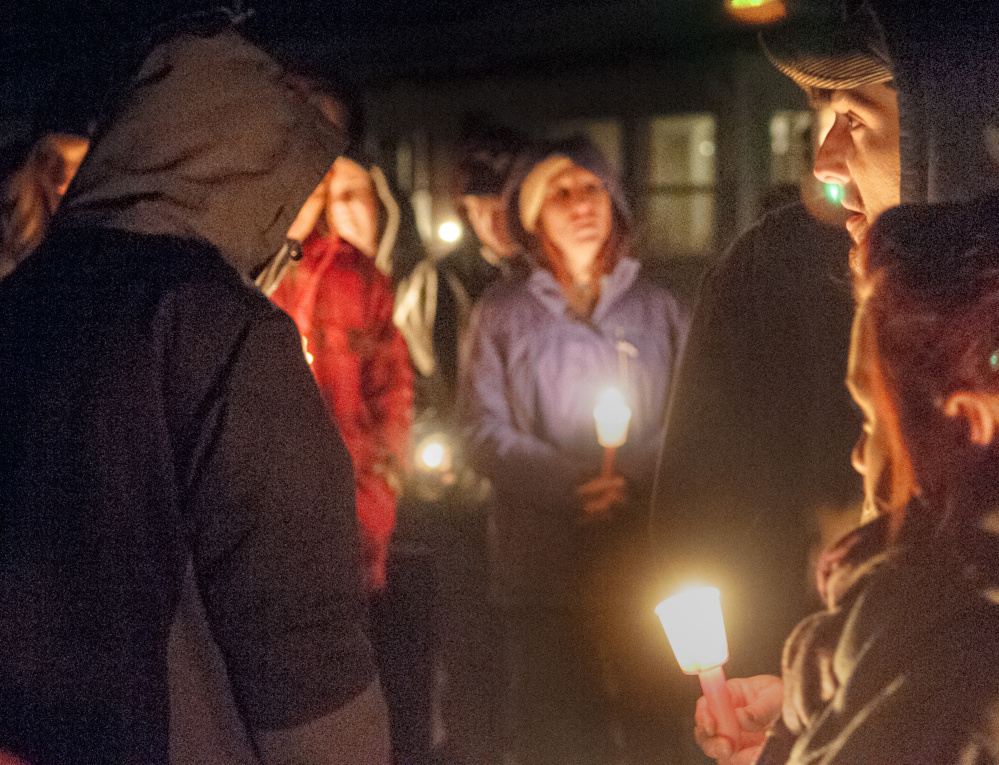 David Jordan leads a recitation of The Lord’s Prayer during a candlelight vigil Friday in Augusta for Eric Williams and Bonnie Royer.