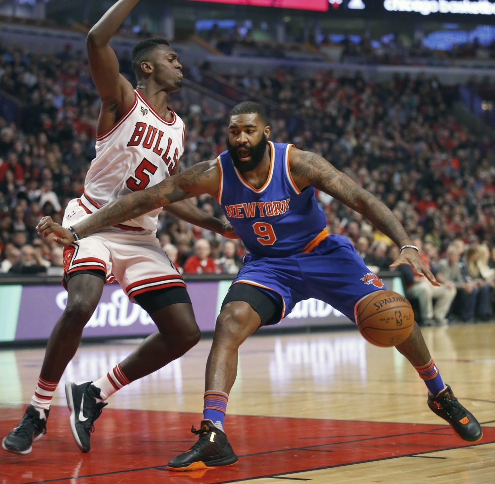 Chicago Bulls forward Bobby Portis guards New York Knicks forward Kyle O’Quinn during the first half of the Bulls’ 108-81 win Friday in Chicago.