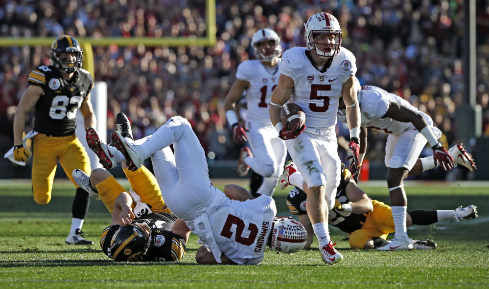Christian McCaffrey of Stanford heads to the end zone Friday against Iowa in the Rose Bowl. McCaffrey scored on a 75-yard pass on the first snap, then on a 66-yard punt return, and gained 368 all-purpose yards in a 45-16 victory.