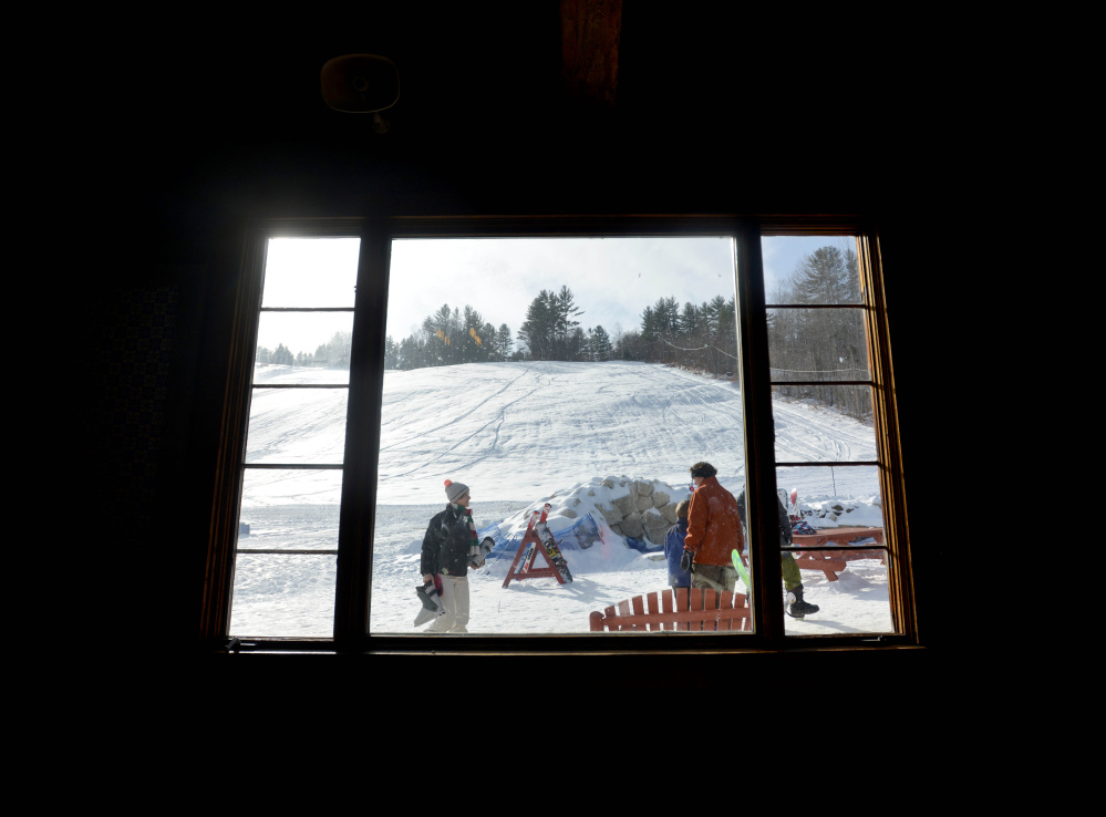 A winter wonderland is finally visible through a lodge window at Titcomb Mountain in West Farmington.