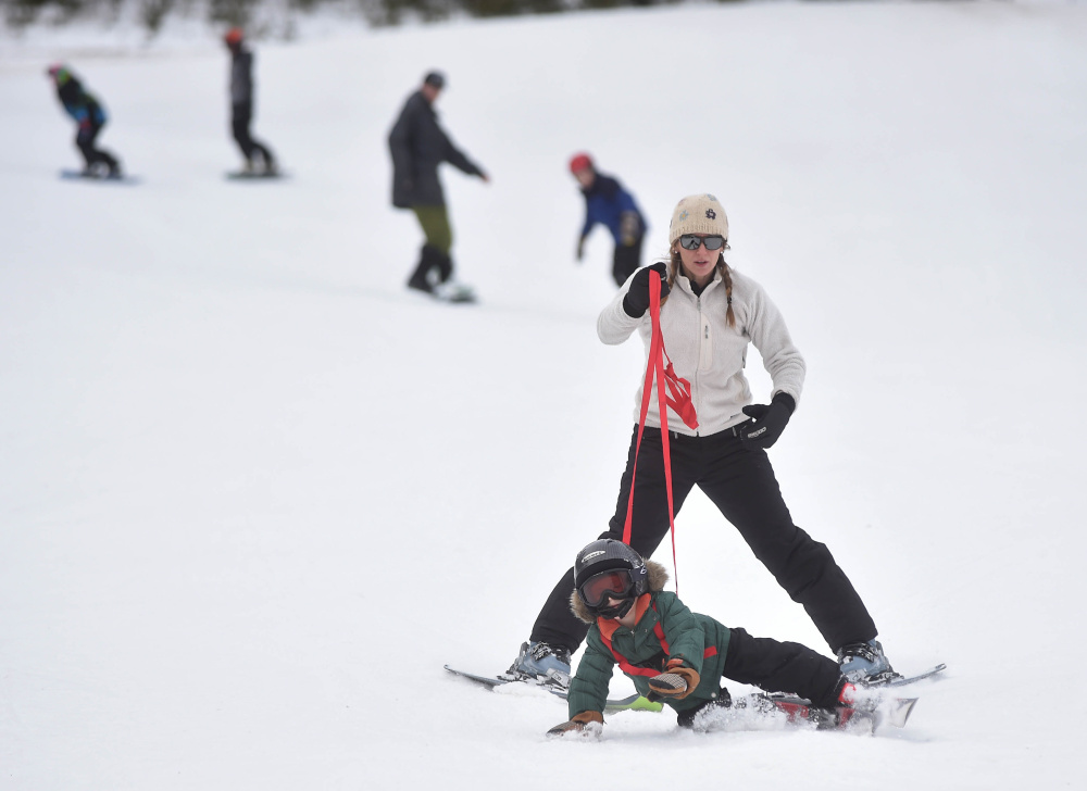 Jessica Eillingwood-Simpson teaches her son Wes, 4, how to ski Saturday at Titcomb Mountain in West Farmington.