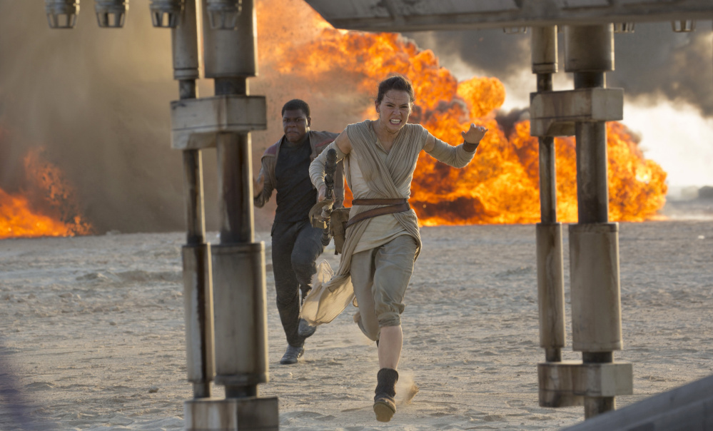 Daisy Ridley and John Boyega are shown in a scene from “Star Wars: The Force Awakens,” directed by J.J. Abrams.