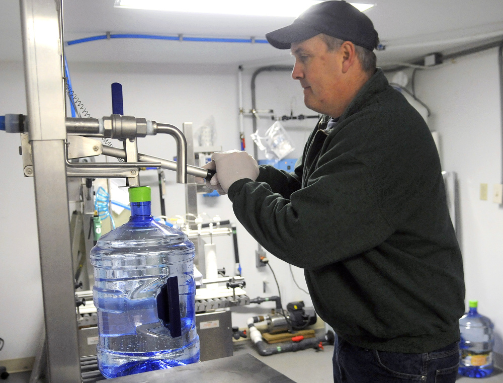 Ed Bowie caps a jug of water last week. Maine Mist was extracted from a well behind his family’s Farmingdale business, the Cobbossee Beverage Shop.
