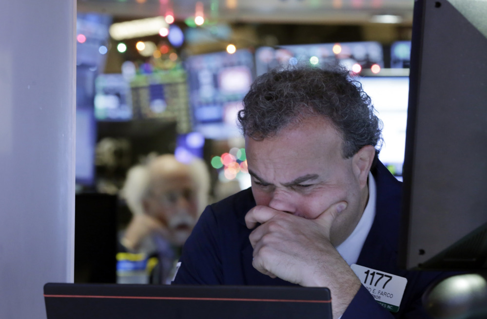 Gerard Farco works on the floor of the New York Stock Exchange on Monday, when the Dow Jones industrial average lost 276 points for the day.