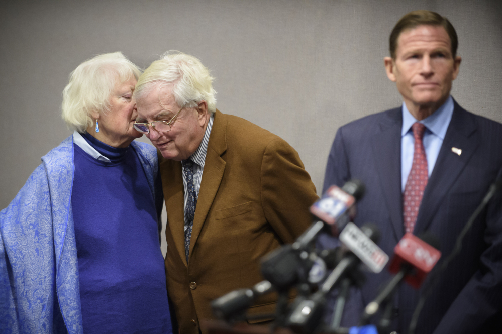 Ellen Kennedy whispers to her husband, Moorhead Kennedy, 85, who was one of 53 American hostages held 444 days at the U.S. Embassy in Iran from 1979 to 1981, during a news conference Monday in Hartford.