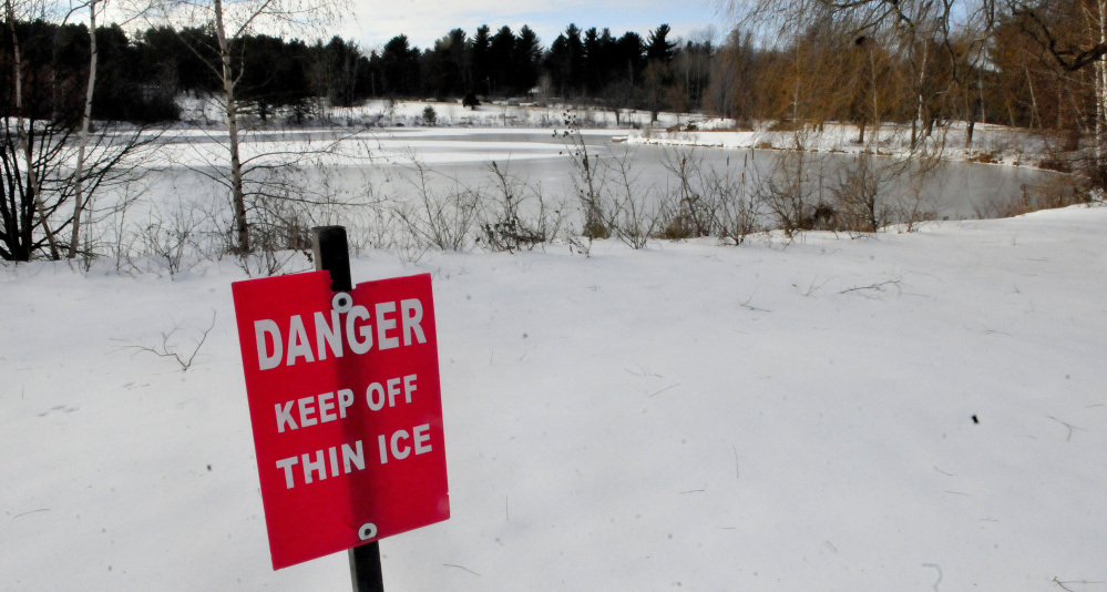 A sign warns skaters to stay off the ice at Johnson Pond on the Colby College campus in Waterville on Monday.
