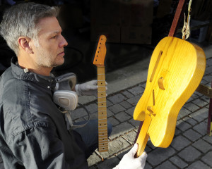Richard Roth inspects the finish on one of his vintage guitars he is rebuilding. Gordon Chibroski/Staff Photographer