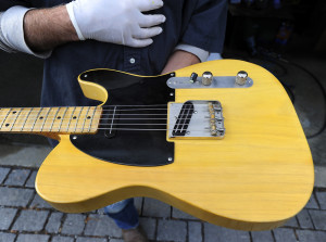 Richard Roth shows off a vintage Fender Telecaster. Gordon Chibroski/Staff Photographer)
