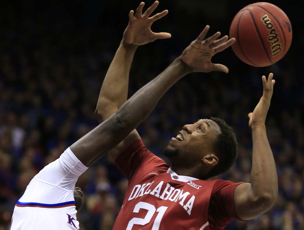 Kansas forward Cheick Diallo, left, knocks the ball away from Oklahoma forward Dante Buford, right, during the first half of an NCAA college basketball game in Lawrence, Kan., Monday, Jan. 4, 2016. (AP Photo/Orlin Wagner)