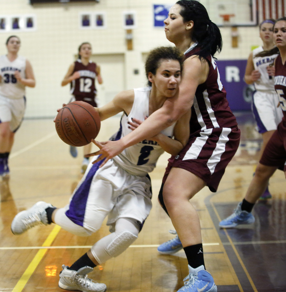Abby Ramirez of Deering powers her way past Makayla Watson of Windham during their game Tuesday.