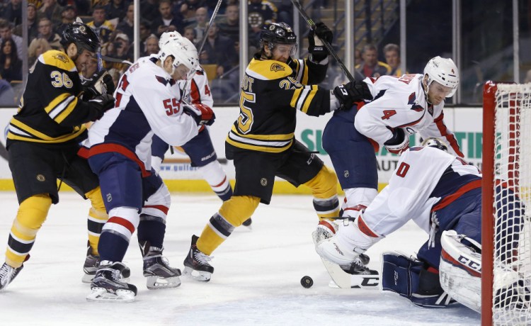 The Bruins’ Max Talbot (25) battles the Capitals’ Aaron Ness (55) for a rebound off goalie Braden Holtby during the second period Tuesday night. The Bruins came up short in a 3-2 home loss.