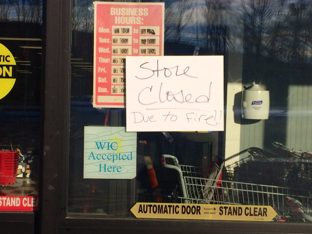 A sign on the front door of Jimmy’s Market on Wednesday announces the store’s closure after a fire.