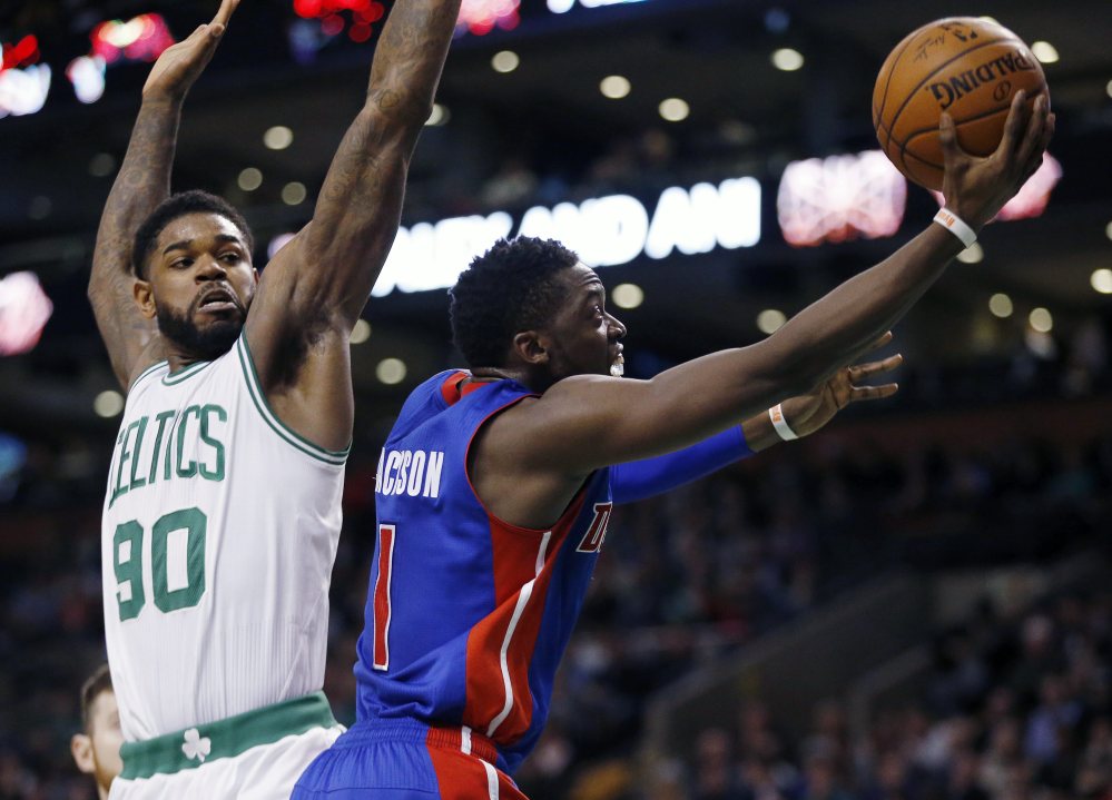 The Pistons’ Reggie Jackson shoots in front of the Celtics’ Amir Johnson on his way to a 24-point game.