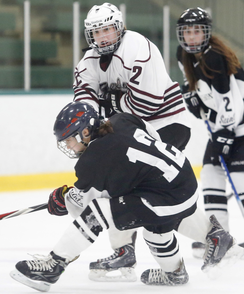 Maura Verrill of Greely watches after firing a shot as she is being checked by Katya Fons of St. Dominic during the second period.