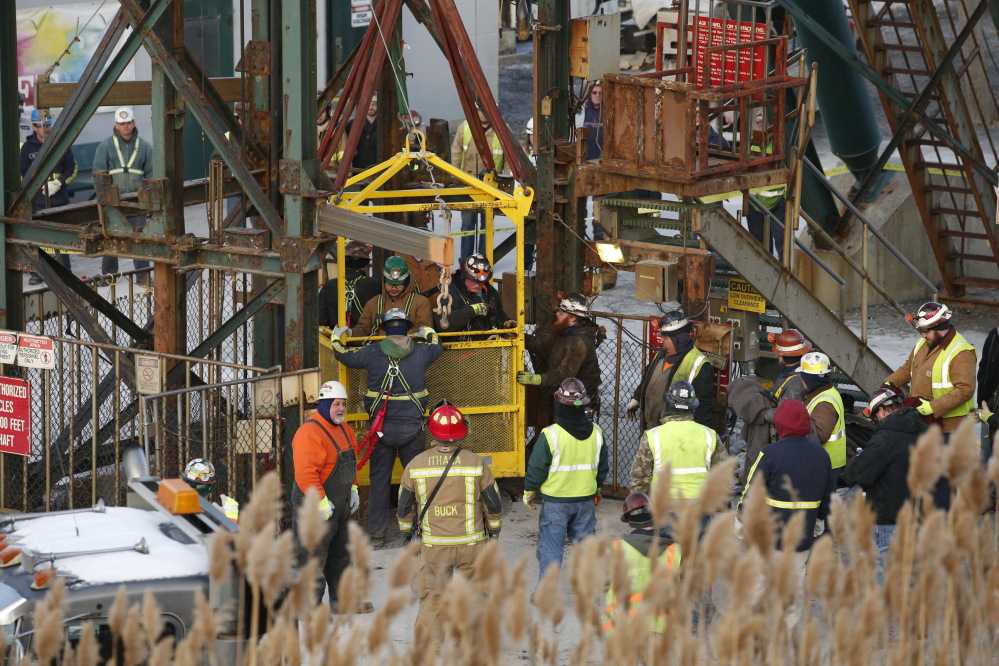 The fourth group of workers emerge from an elevator Thursday after being stuck overnight in a shaft at the Cayuga Salt Mine in Lansing, N.Y. Cargill Inc. spokesman Mark Klein said all 17 miners have been rescued.